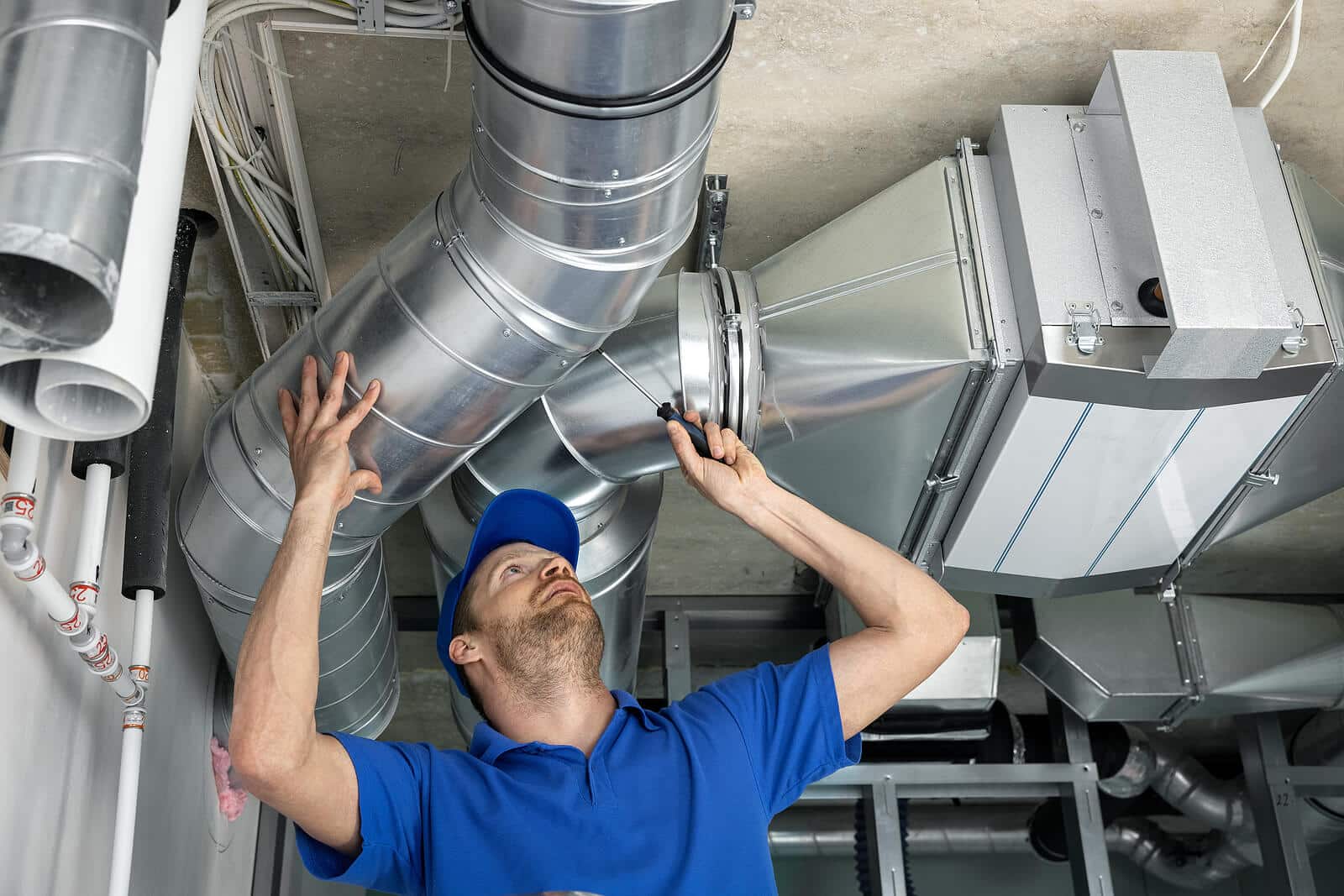 HVAC technician inspecting and repairing air ducts in Stockton