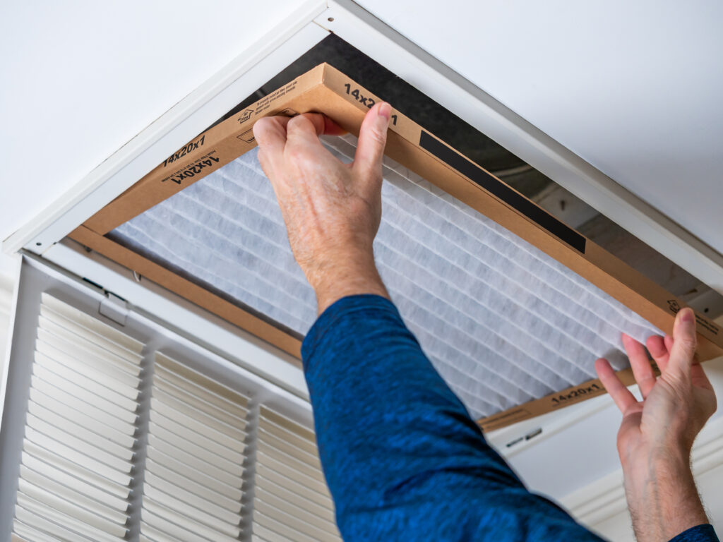 HVAC technician replacing a home air filter in Stockton