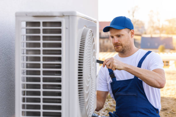 HVAC technician servicing an outdoor air conditioner in Stockton